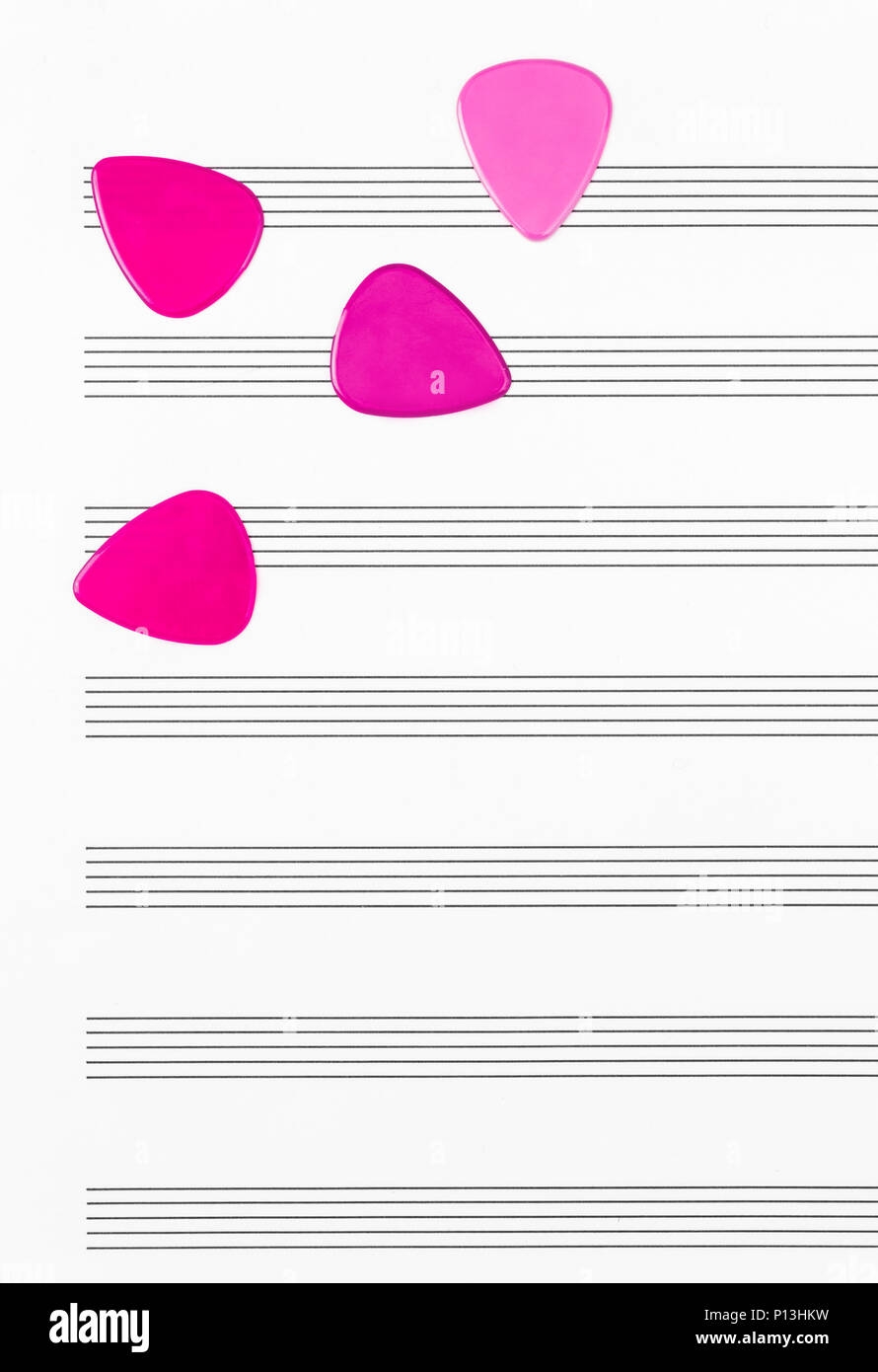 Vibrant Crimson Guitar Picks On Empty Sheet Music Paper Stock Photo Alamy