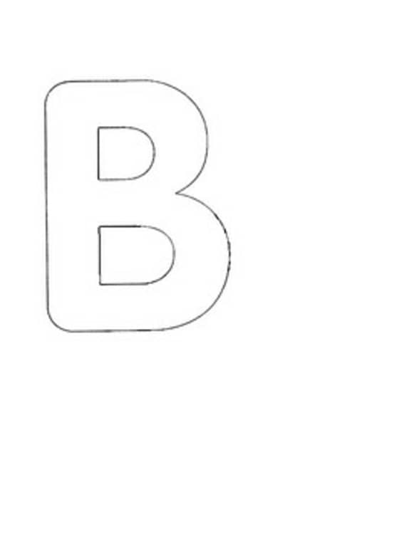 Child tracing letter A over stencil with pencil